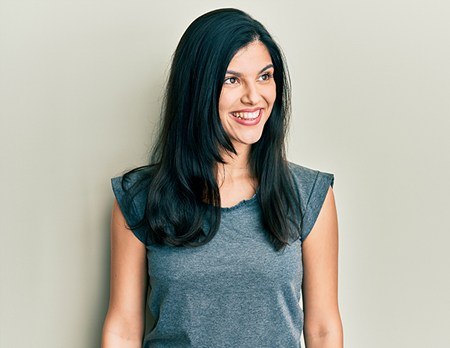 A photo of a young hispanic woman wearing enjoying facial implants