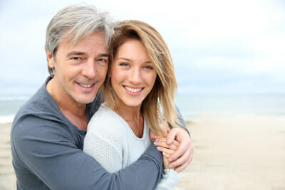 A photo of a happy couple on beach after mini facelift