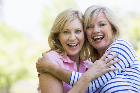 Two women with full faces laughing