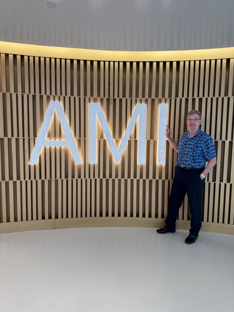 Dr. Peña in front of AMI sign